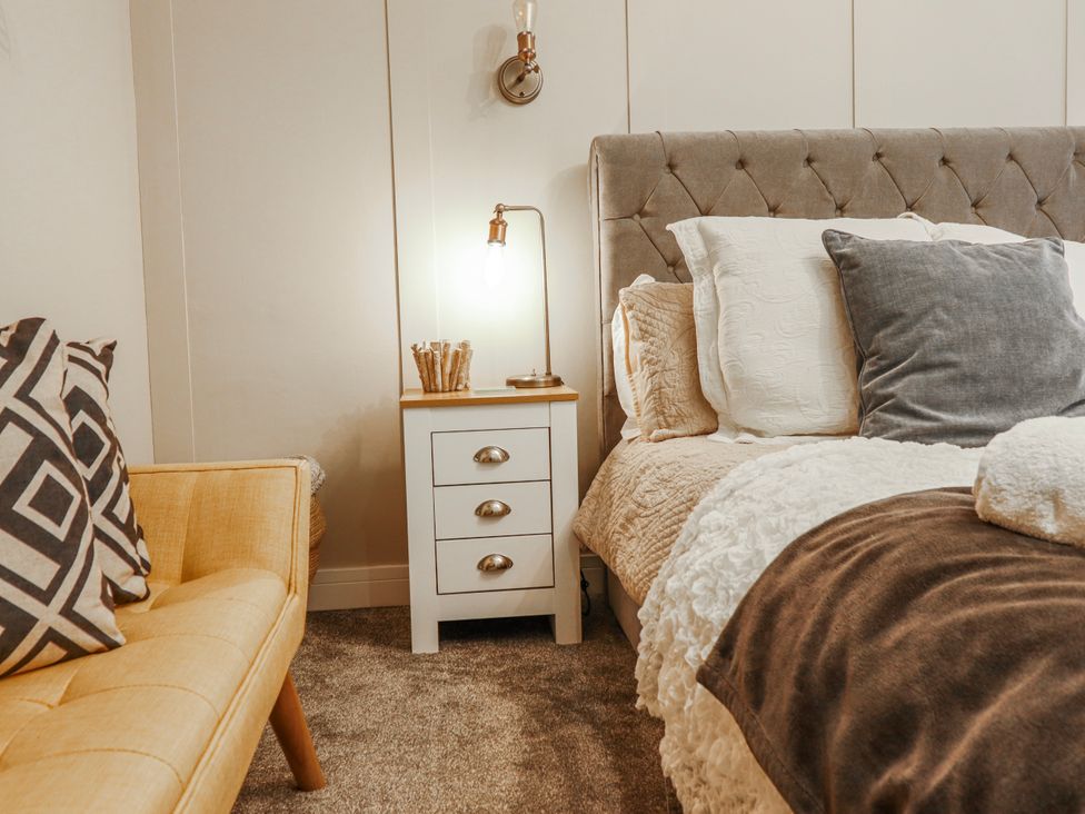 A bedroom with a bed and nightstand at Hafod Y Bryn in Harlech
