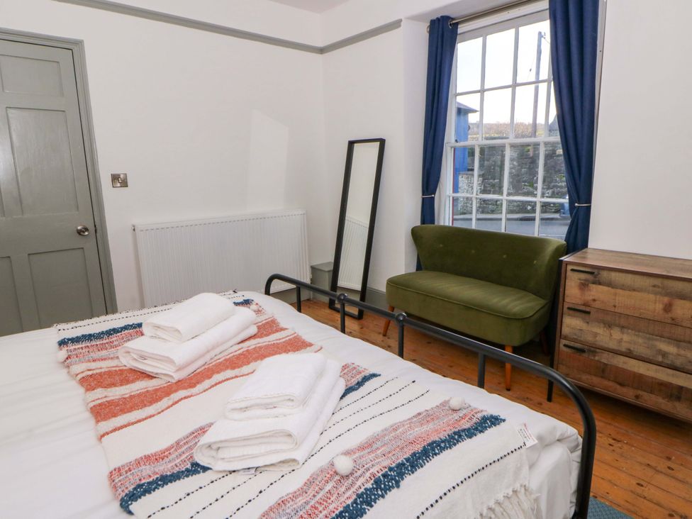 A bedroom with a bed and towels on it at Island House in Aberaeron