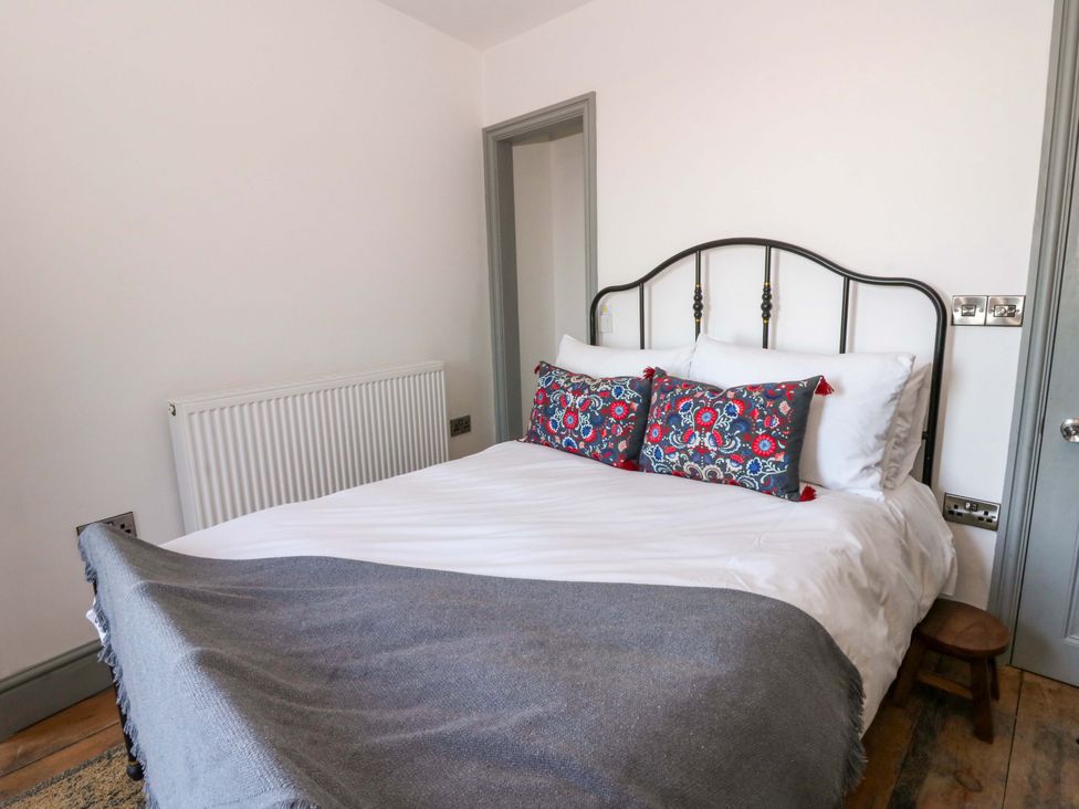 A bedroom with a bed and pillows at Island House in Aberaeron