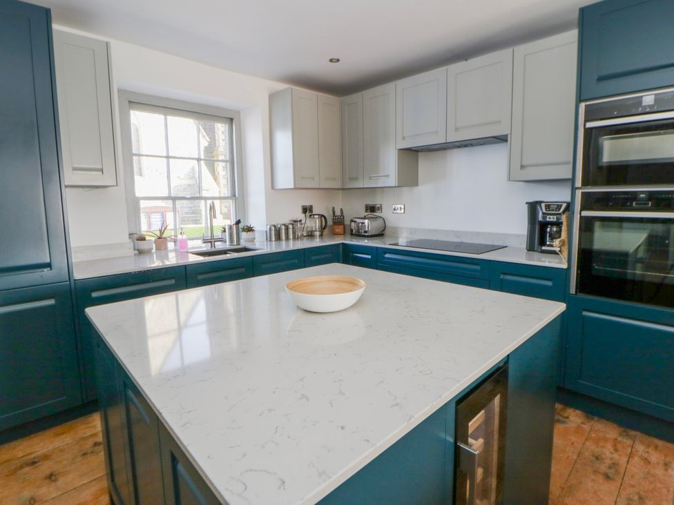 A kitchen with cabinets and a countertop at Island House Aberaeron