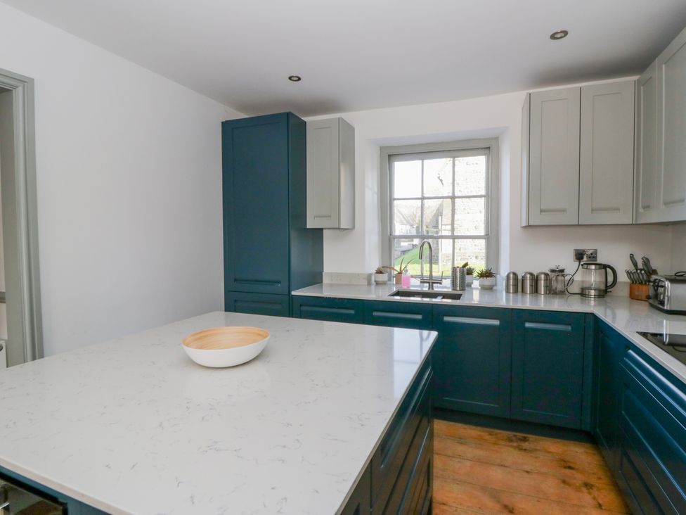 A kitchen with a countertop and sink at Island House Aberaeron