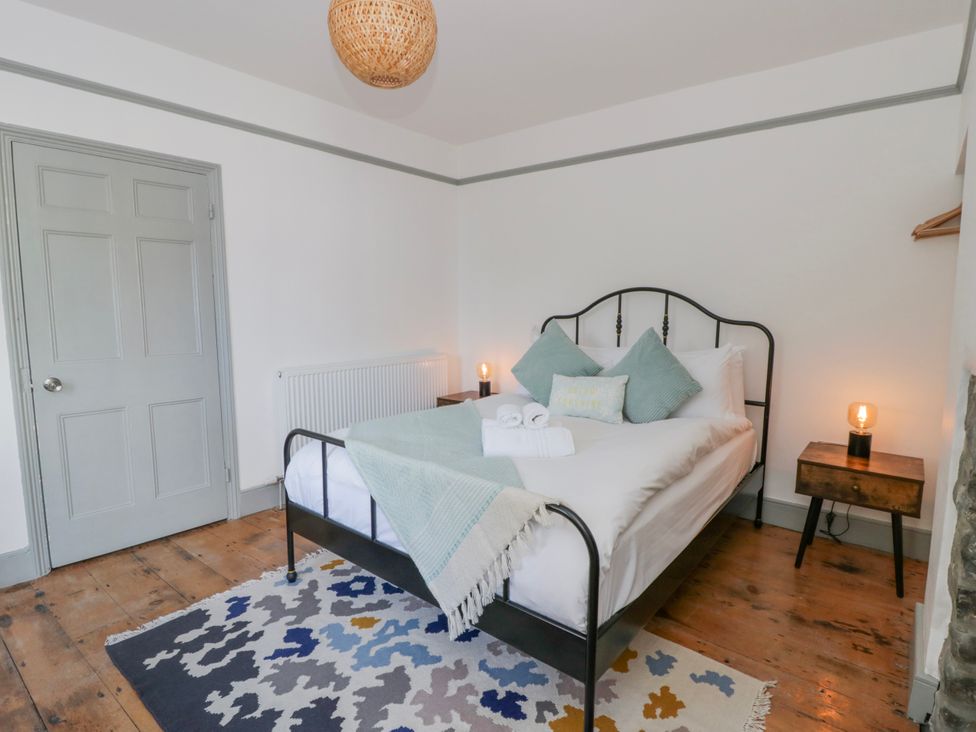 A bedroom with a bed and bedside table at Island House in Aberaeron