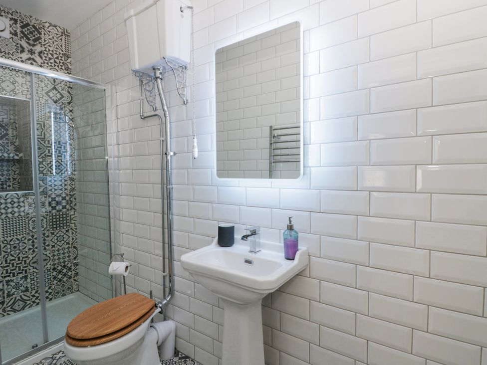 A bathroom with a toilet, sink, and shower at Island House in Aberaeron
