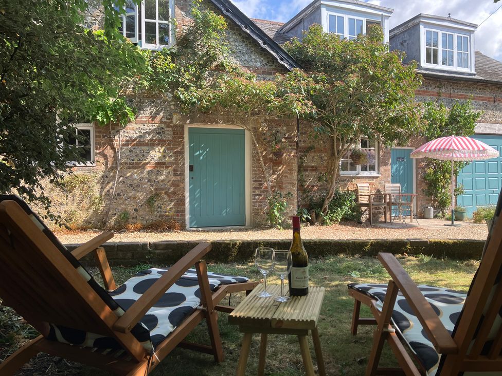 A garden view with chairs and a table at The Coach House - Trinity Lodge Godmanstone near Cerne Abbas