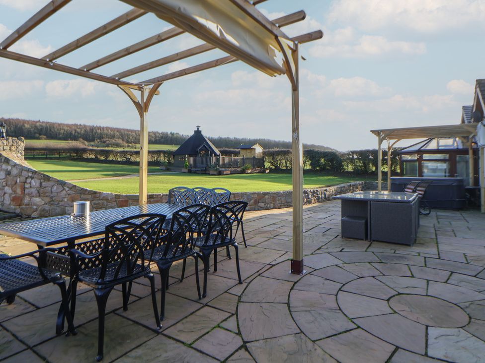 An outdoor space with a table and chairs at Brookway Lodge Caerwys