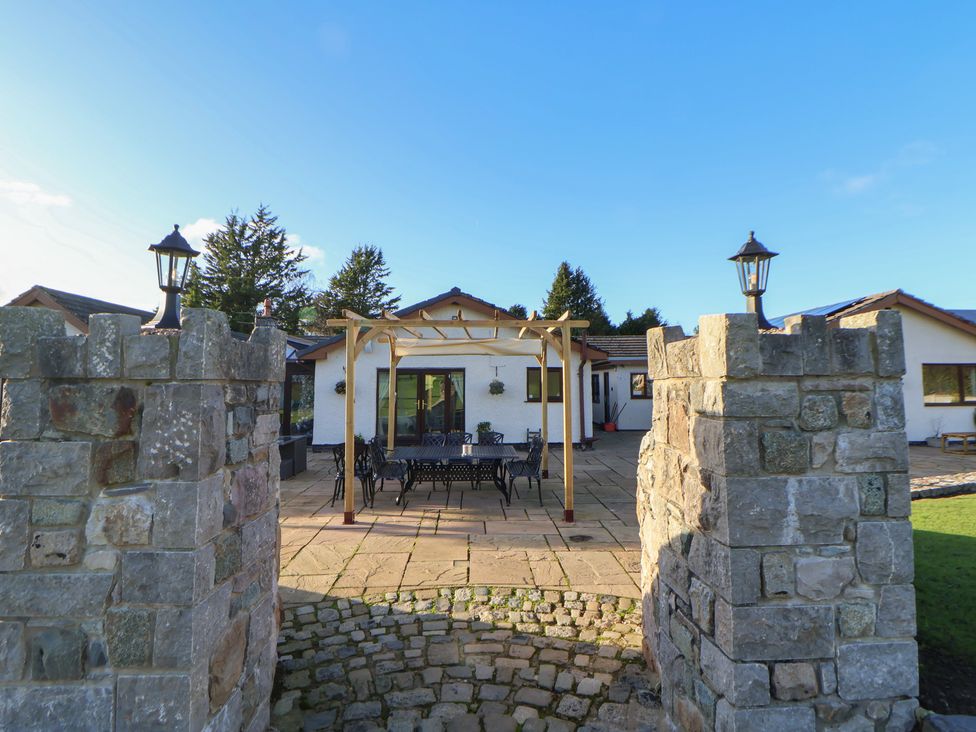 An outdoor area with a gazebo and furniture at Brookway Lodge in Caerwys