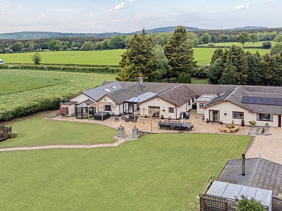 A house with a garden and patio at Brookway Lodge in Caerwys