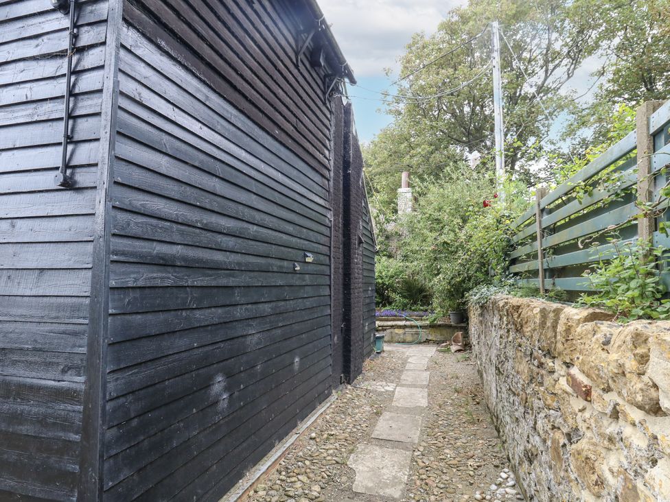 An outdoor area with a pathway beside a building at Chenies in Osmington Mills, near Preston