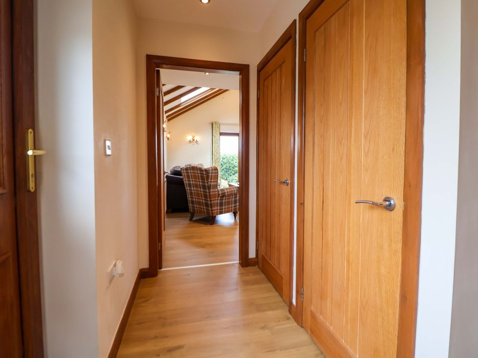 A hallway with two doors leading to other rooms at The Brambles in Holt, North Wales