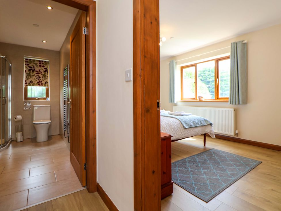 A bathroom with a shower and toilet at The Brambles in Holt, North Wales