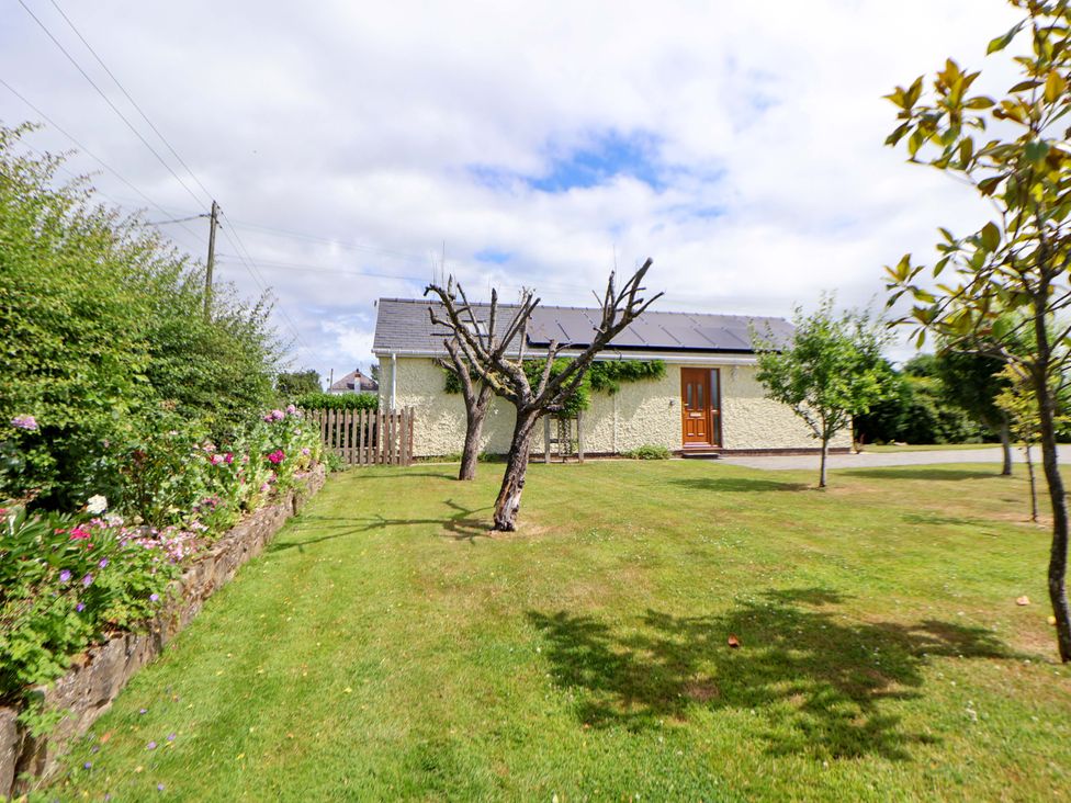 An outdoor space with a house and garden features at The Brambles in Holt, North Wales