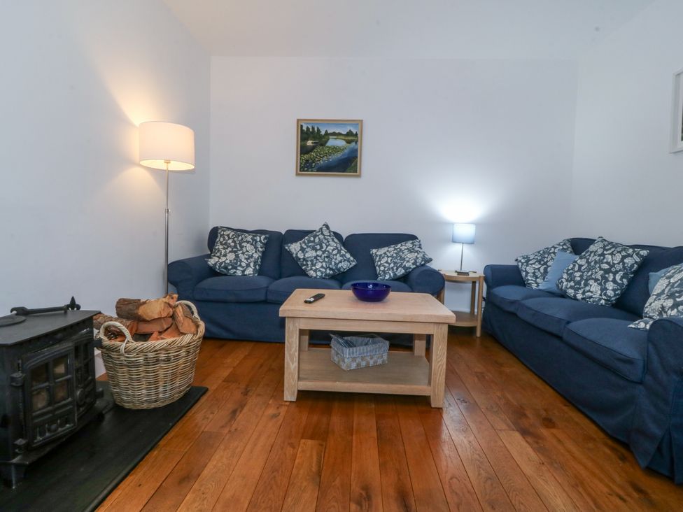 A living room with a sofa and a coffee table at Ty Capel Bethania in Nant Gwynant
