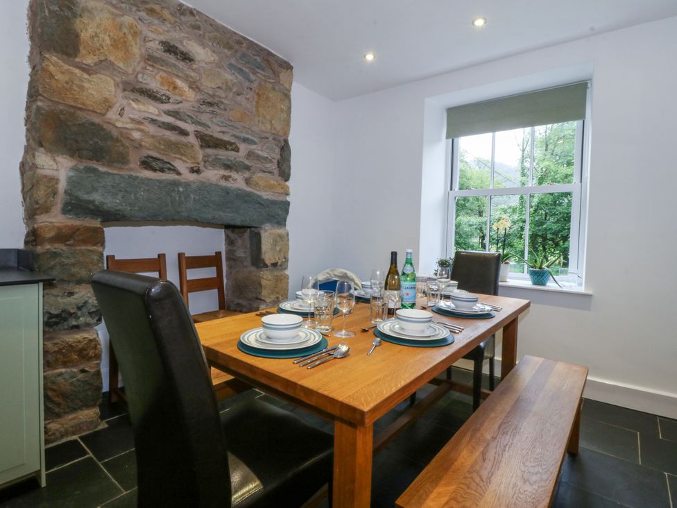 A dining room with a table set for a meal at Ty Capel Bethania in Nant Gwynant