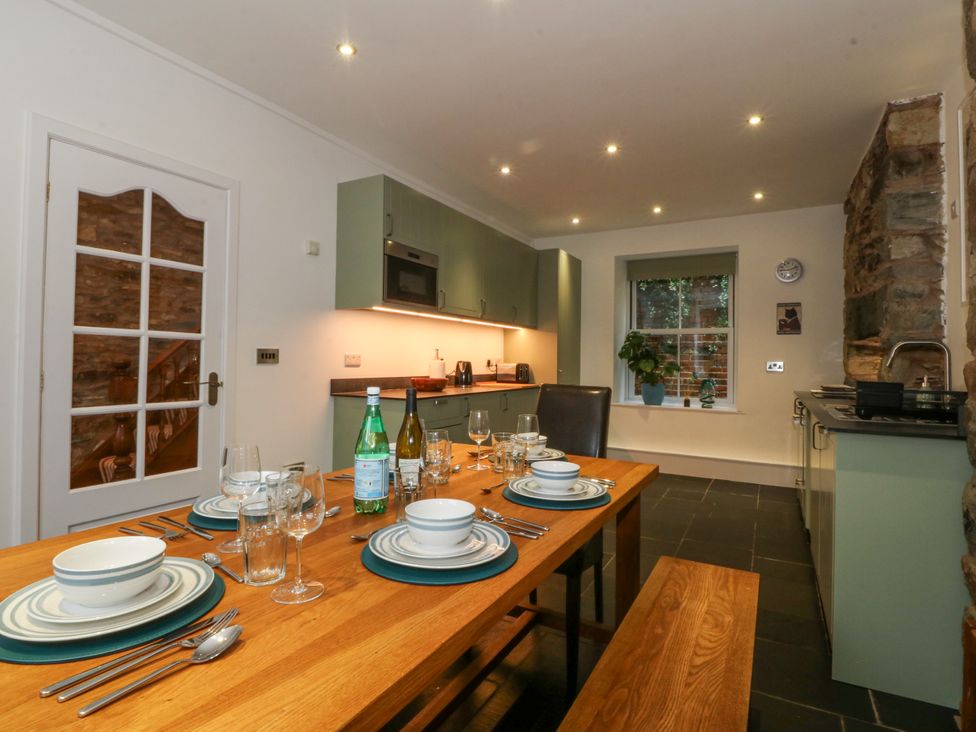 A kitchen with a dining table set at Ty Capel Bethania in Nant Gwynant