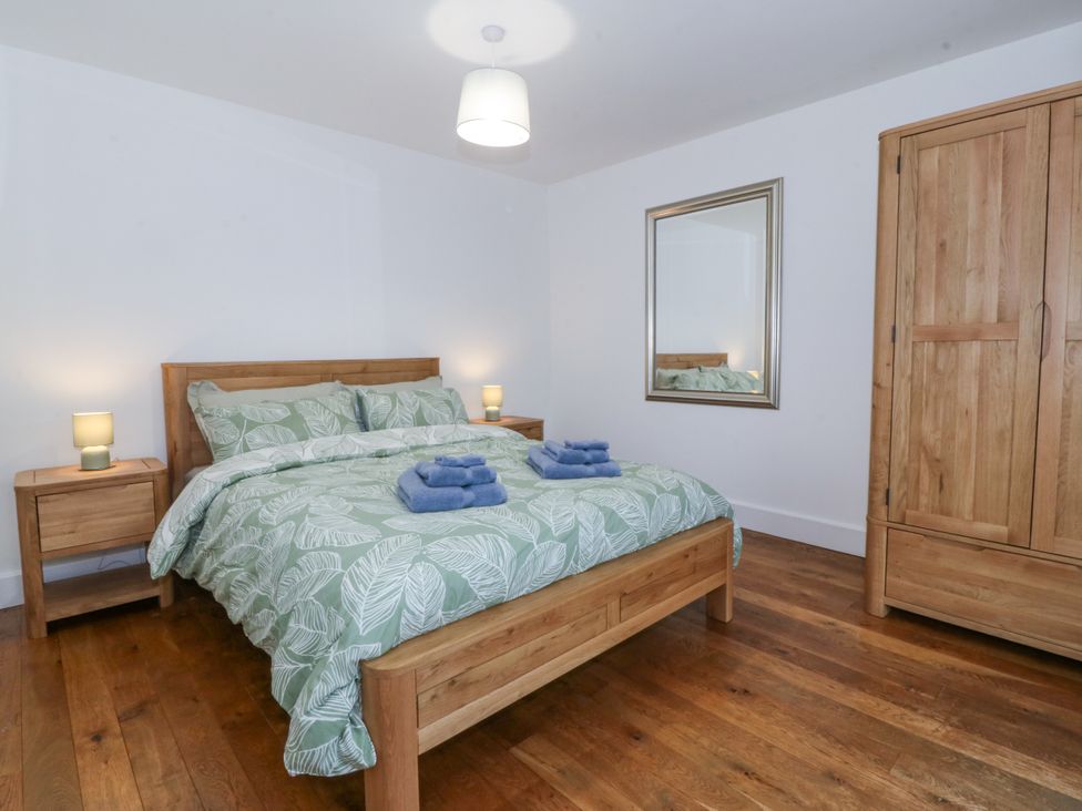 A bedroom with a bed and wardrobe at Ty Capel Bethania in Nant Gwynant