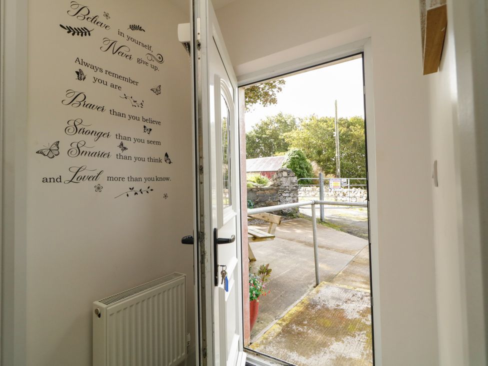 An entrance with wall decor and an open door at Duffy Lodge Kilmacloo near Creeslough County Donegal