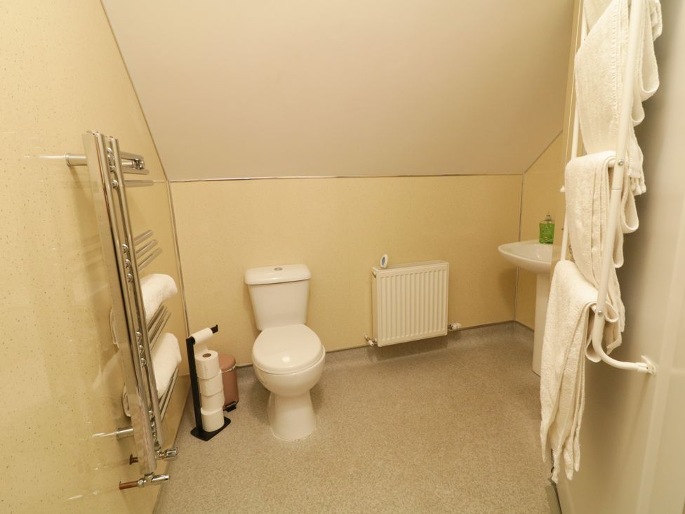 A bathroom with a toilet and sink at Duffy Lodge Kilmacloo near Creeslough County Donegal