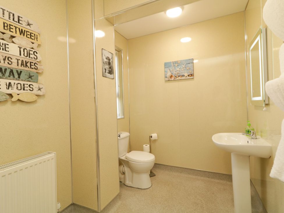 A bathroom with a sink and toilet at Duffy Lodge in Kilmacloo near Creeslough, County Donegal