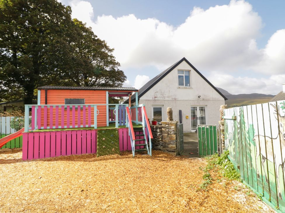 An outdoor area with a house and playhouse at Duffy Lodge in Kilmacloo near Creeslough, County Donegal