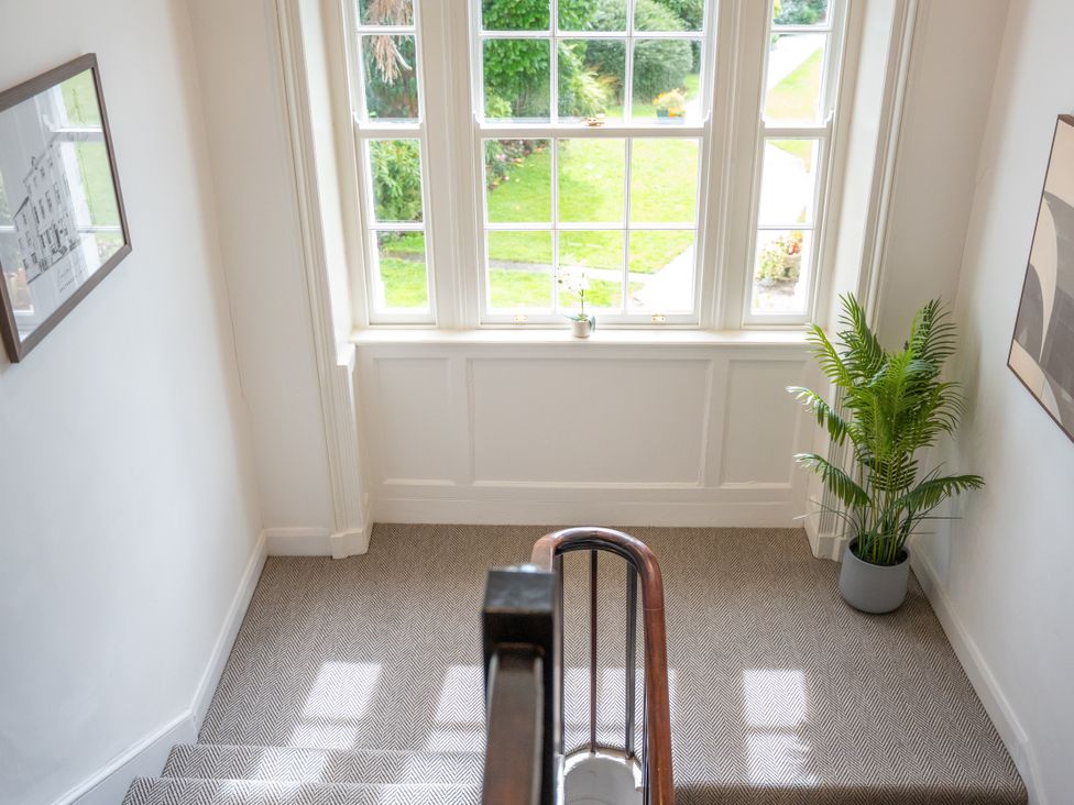 A staircase with a window and plant at Ullswater in Ulverston