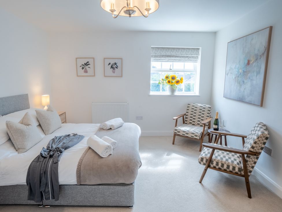 A bedroom with a bed and seating area at Ullswater in Ulverston
