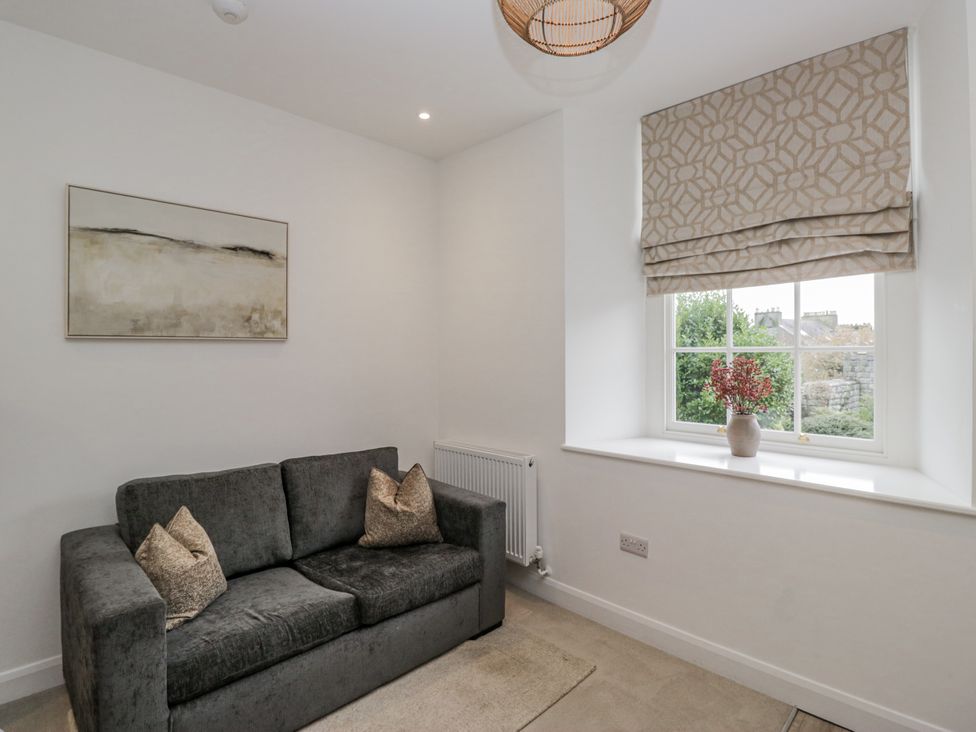 A living room with a sofa and window at Ullswater in Ulverston