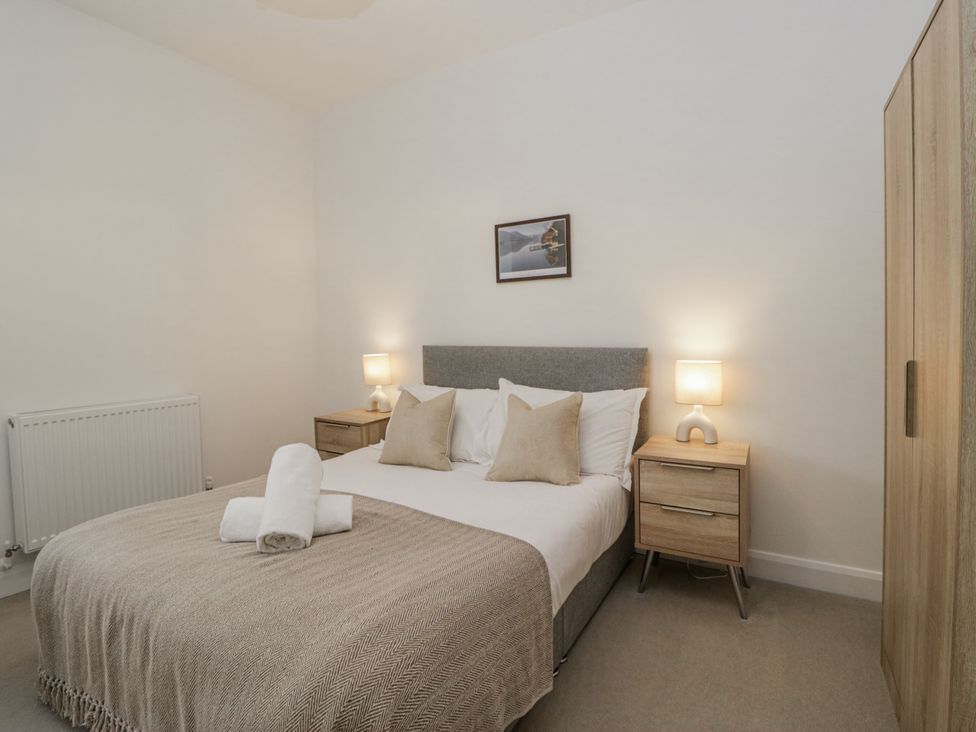 A bedroom with a bed and bedside tables at Ullswater in Ulverston