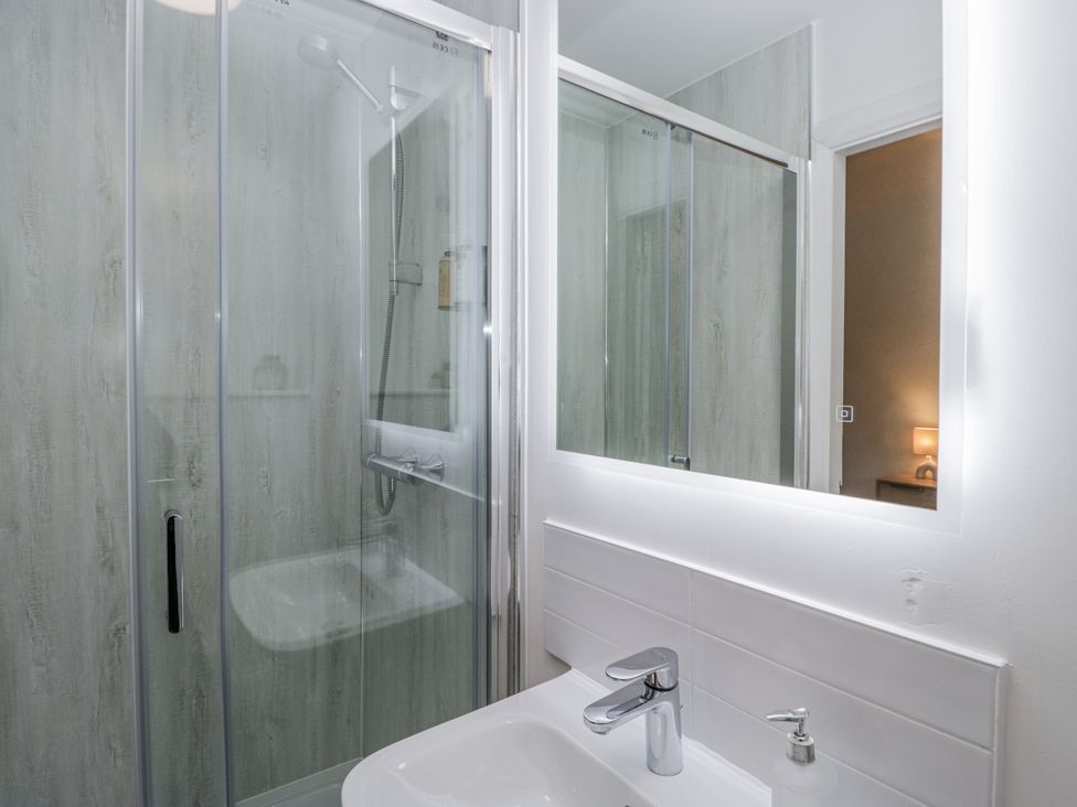 A bathroom with a shower and sink at Ullswater in Ulverston