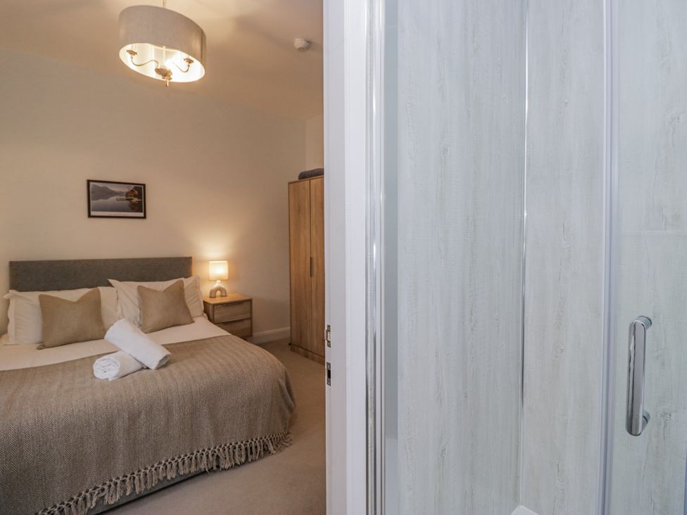 A bedroom with a bed and wardrobe at Ullswater in Ulverston