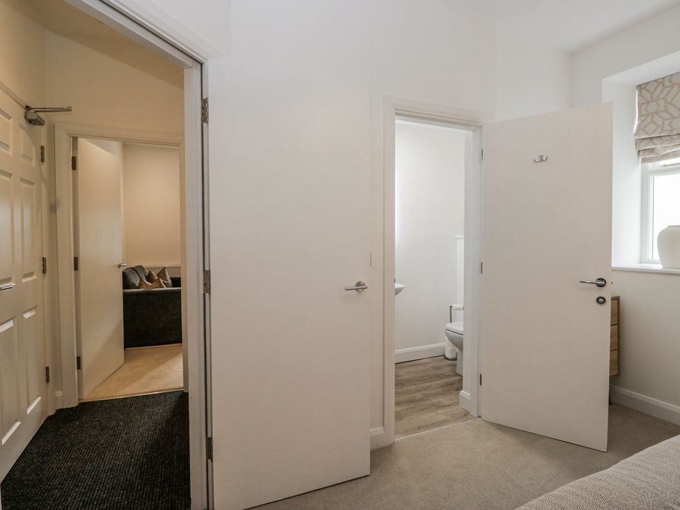 A bathroom with a toilet visible from the hallway at Ullswater in Ulverston