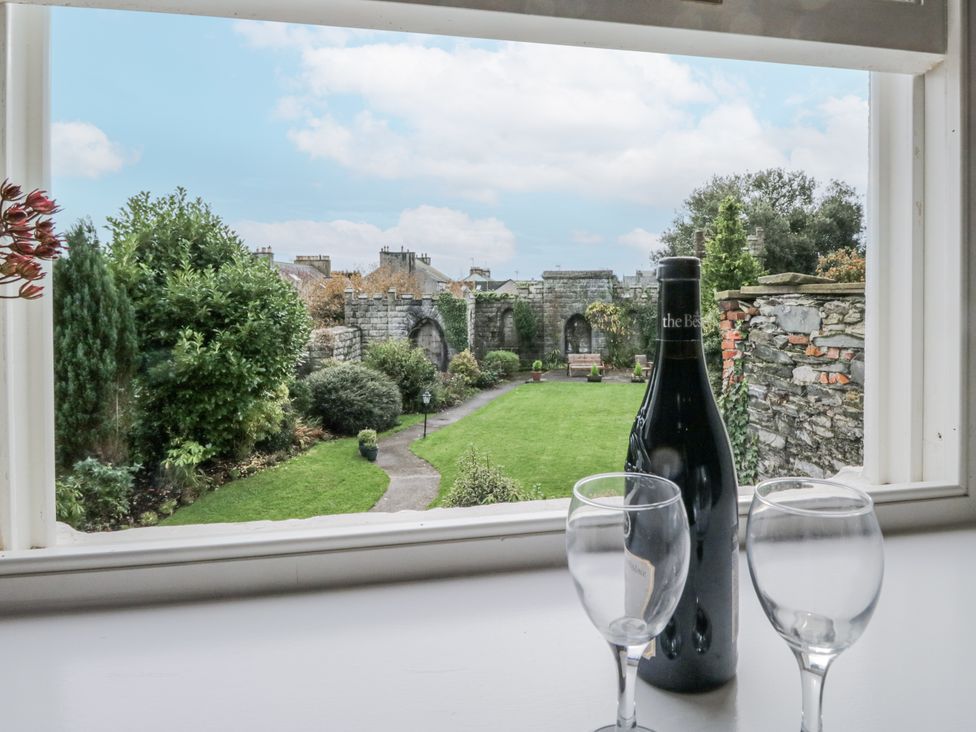 A view of a garden with a bottle and glasses at Ullswater in Ulverston