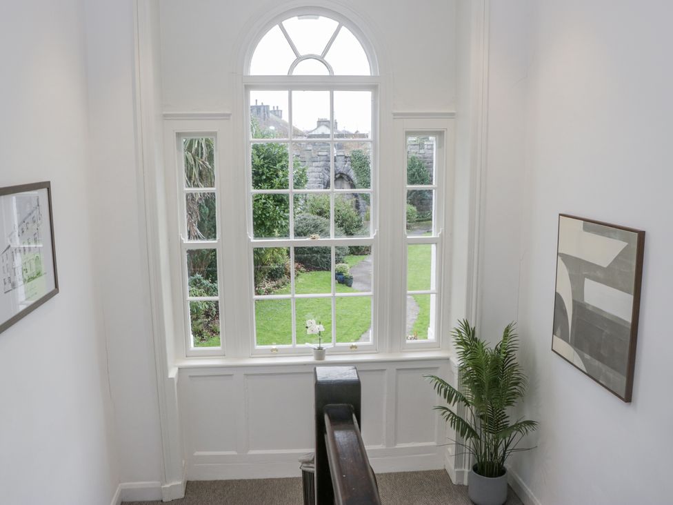 A staircase with a window and plant at Ullswater in Ulverston