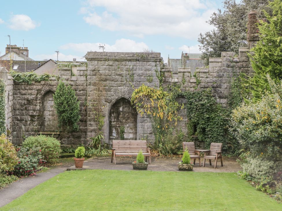A garden with stone wall and seating area at Ullswater in Ulverston