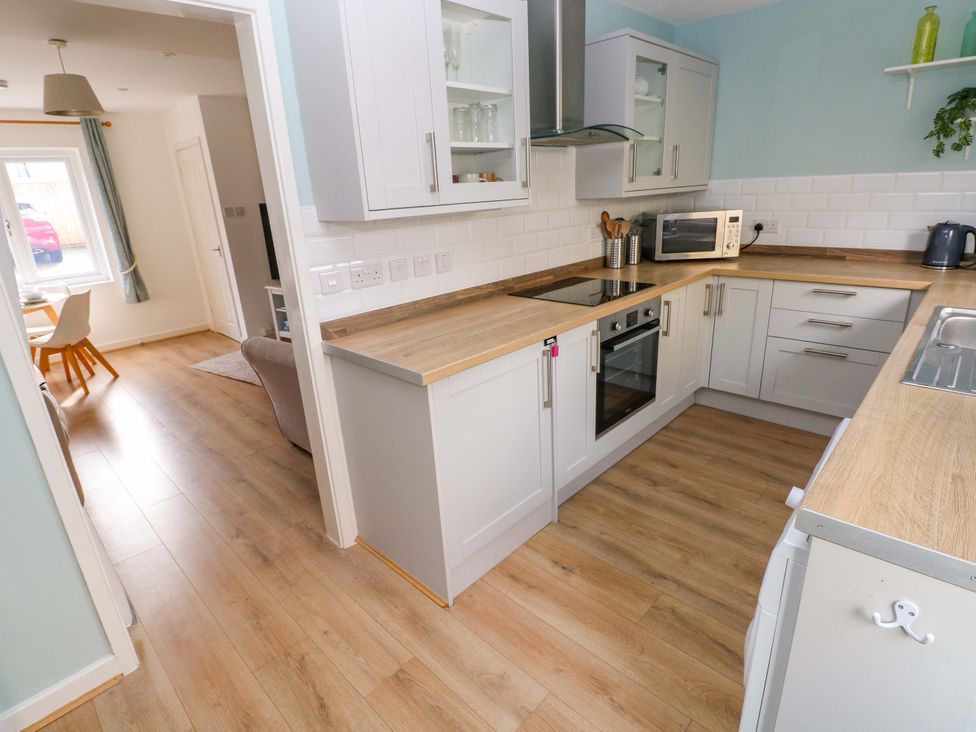 A kitchen with an oven, countertop, and microwave at No.22 The Clicketts Tenby
