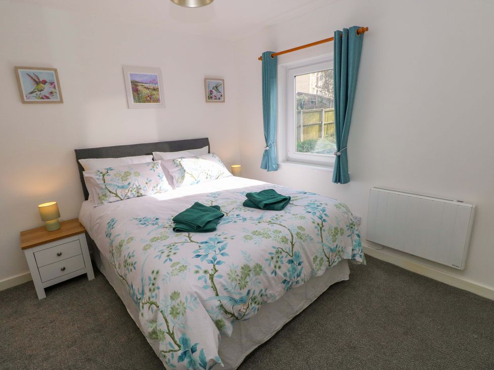 A bedroom with a bed and window at No.22 The Clicketts Tenby