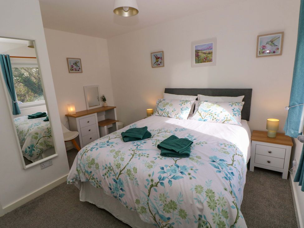 A bedroom with a double bed and side tables at No.22 The Clicketts in Tenby