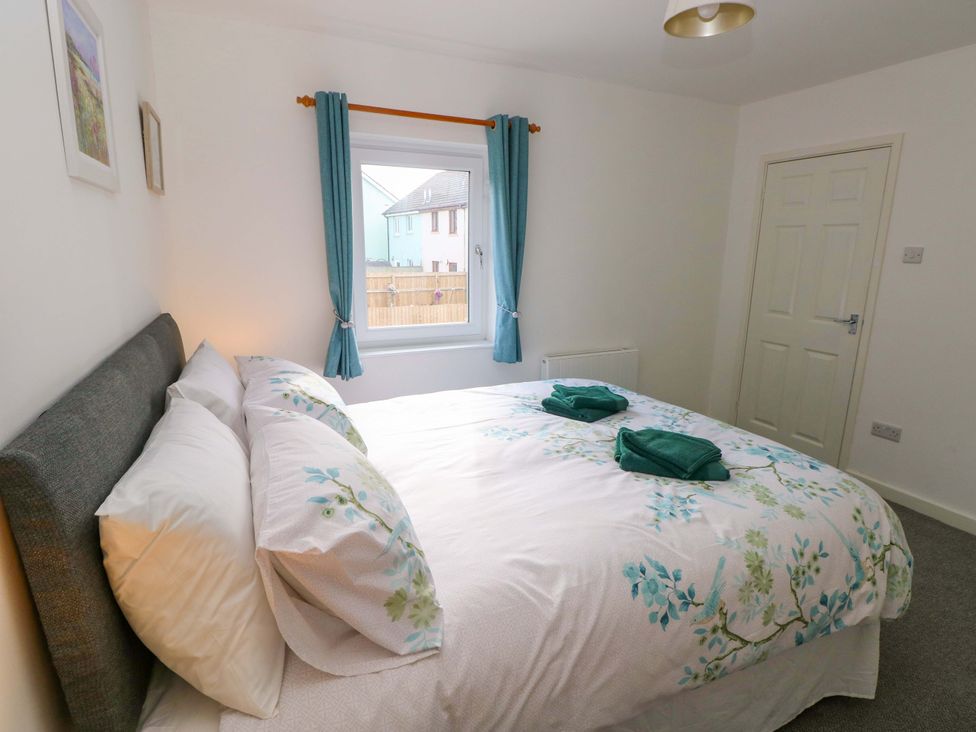 A bedroom with a bed and window at No.22 The Clicketts in Tenby