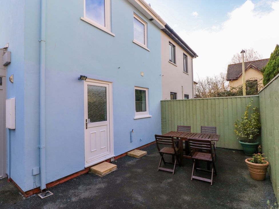 An outdoor area with a table and chairs at No.22 The Clicketts in Tenby