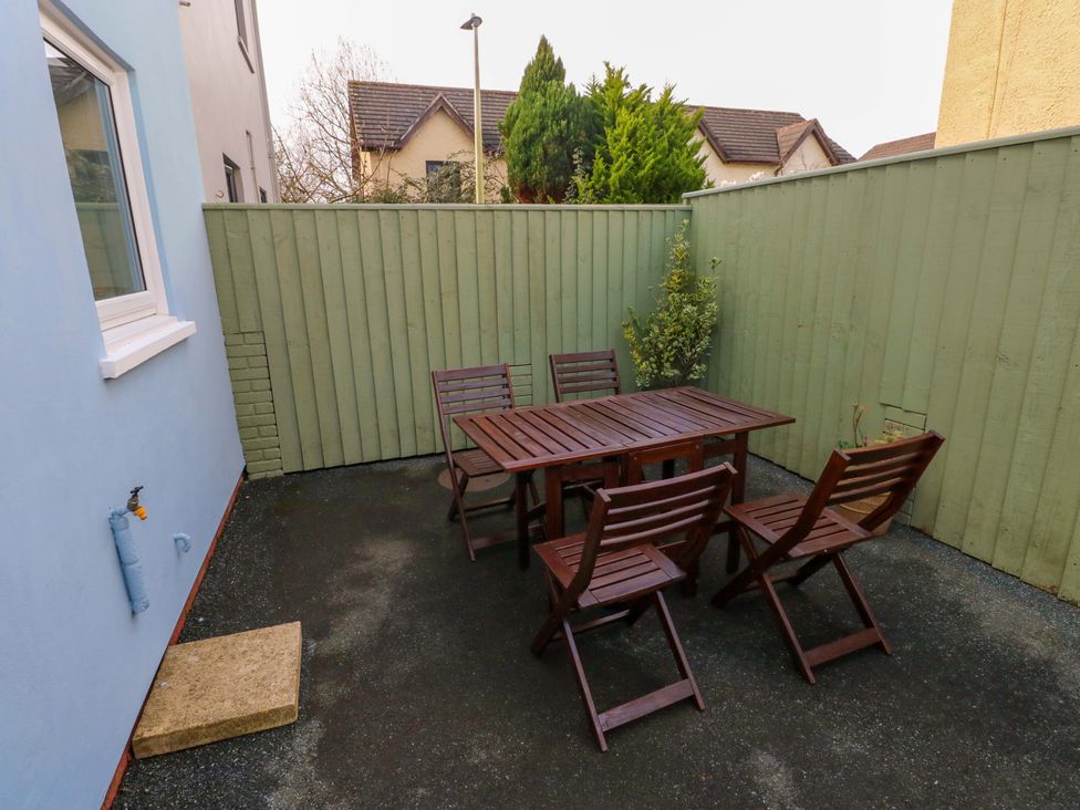 An outdoor seating area with a table and chairs at No.22 The Clicketts Tenby