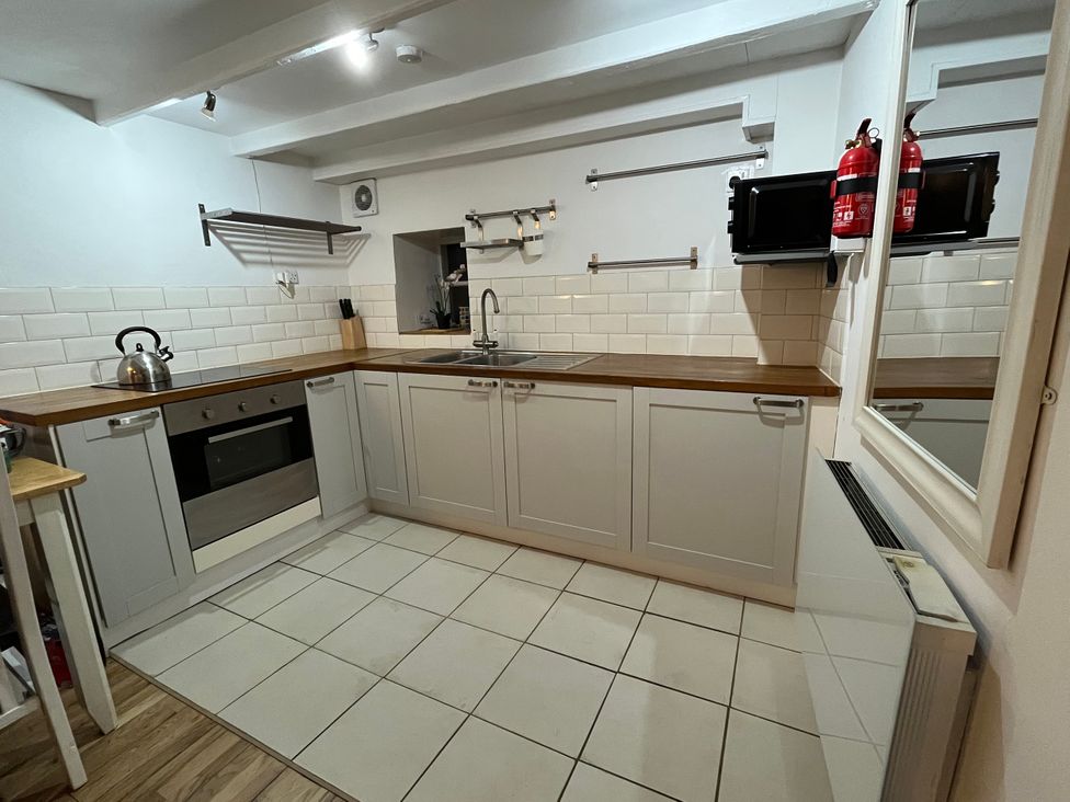 A kitchen with cabinets and appliances at Hinderwell House in Staithes
