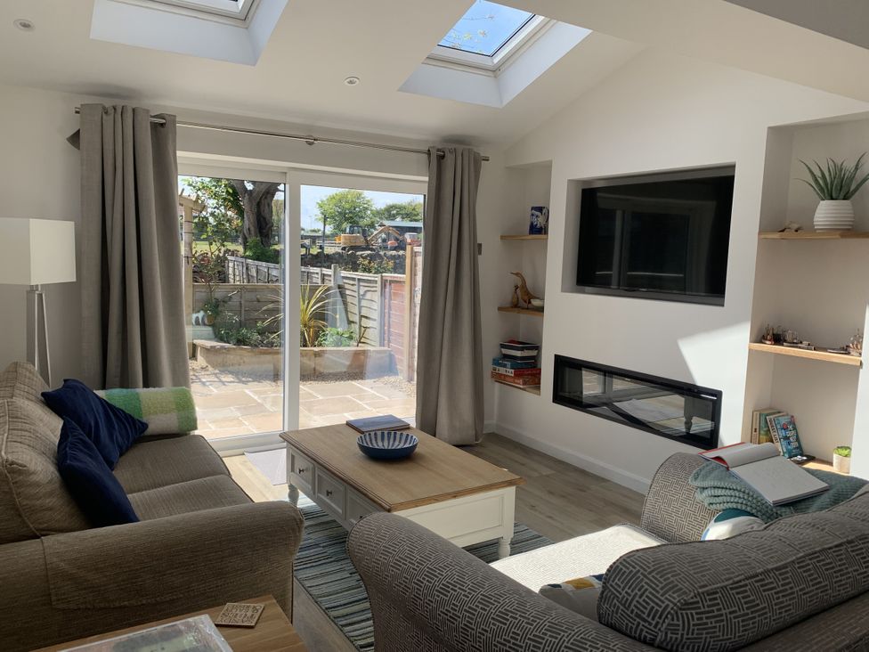 A living room with a coffee table and sofa at Lavender Cottage in Beadnell