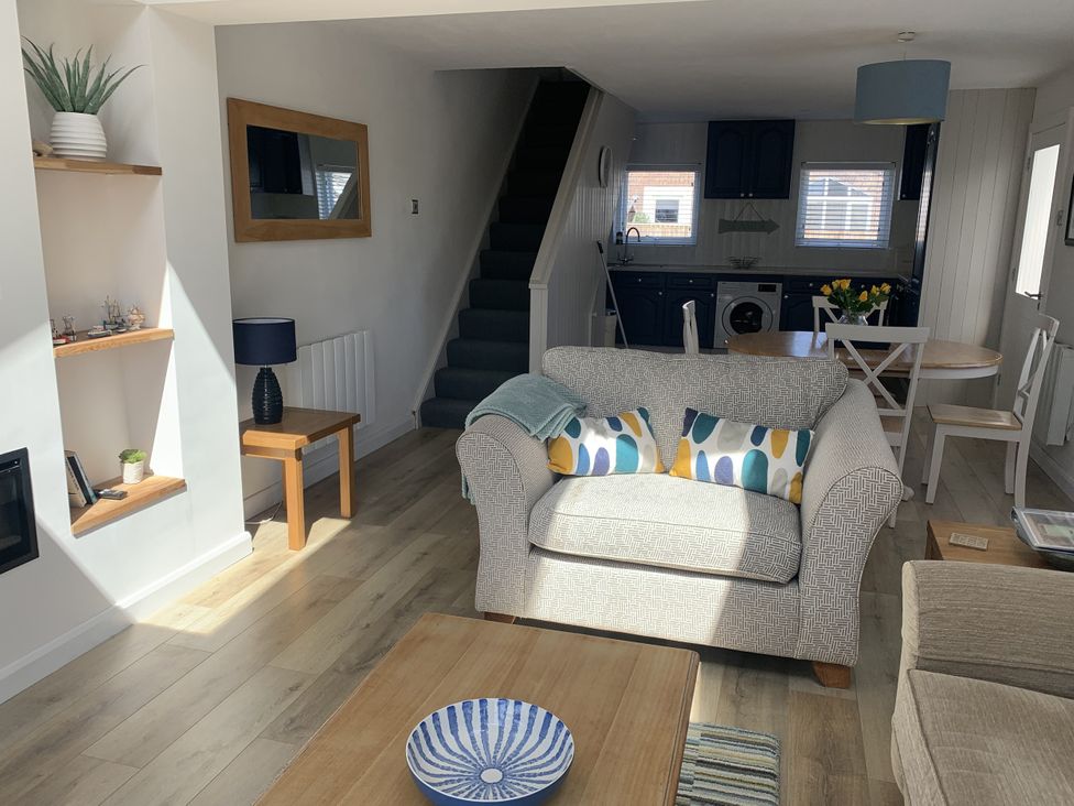 A living room with a sofa and coffee table at Lavender Cottage Beadnell