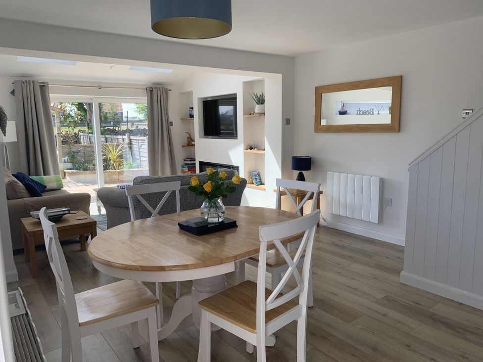 A living room with a dining table and chairs at Lavender Cottage Beadnell