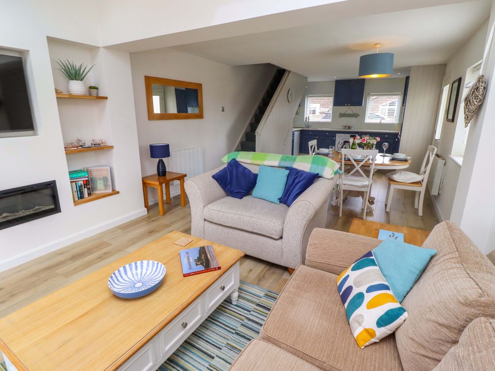 A living room with a sofa and coffee table at Lavender Cottage Beadnell