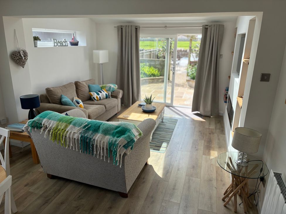 A living room with a sofa and coffee table at Lavender Cottage in Beadnell