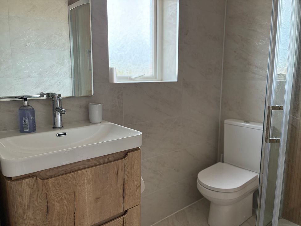 A bathroom with a sink and toilet at Lavender Cottage in Beadnell