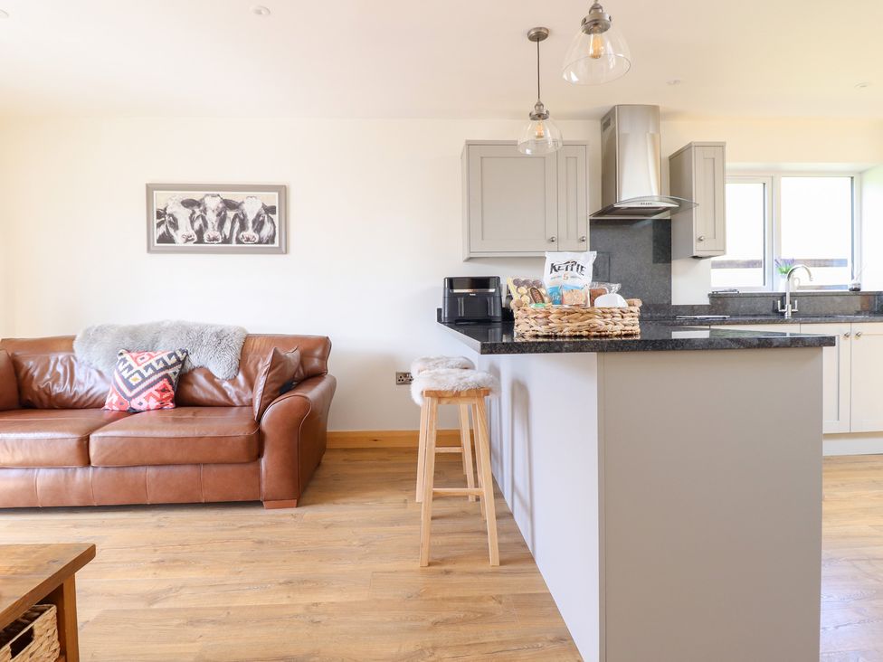 A kitchen with a sofa and kitchen island at Bryn Bras in Corwen