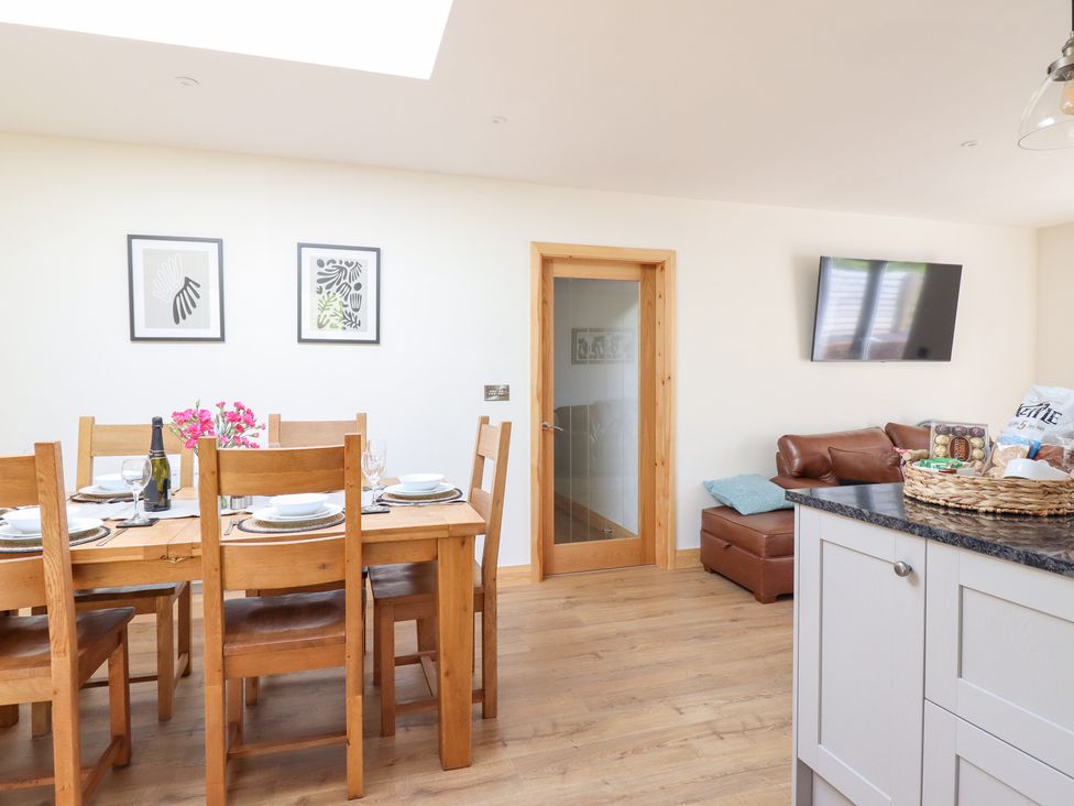 A dining room with a table set for dinner at Bryn Bras in Corwen