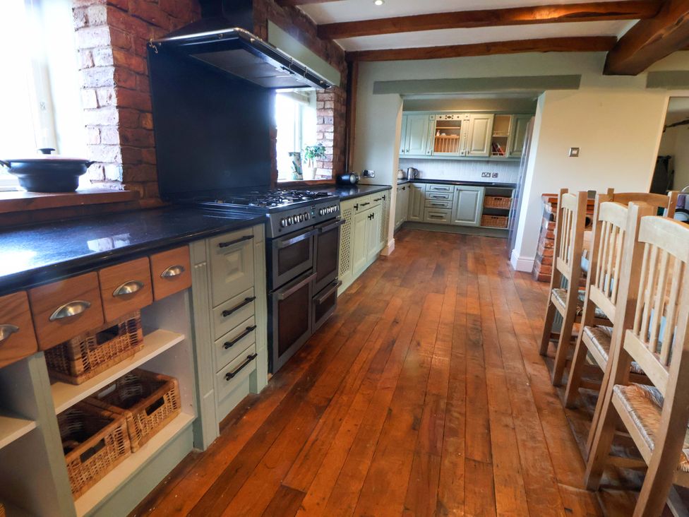 A kitchen with cabinets and an oven at Home Farm St Asaph