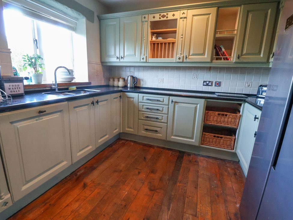 A kitchen with cabinets and a sink at Home Farm St Asaph